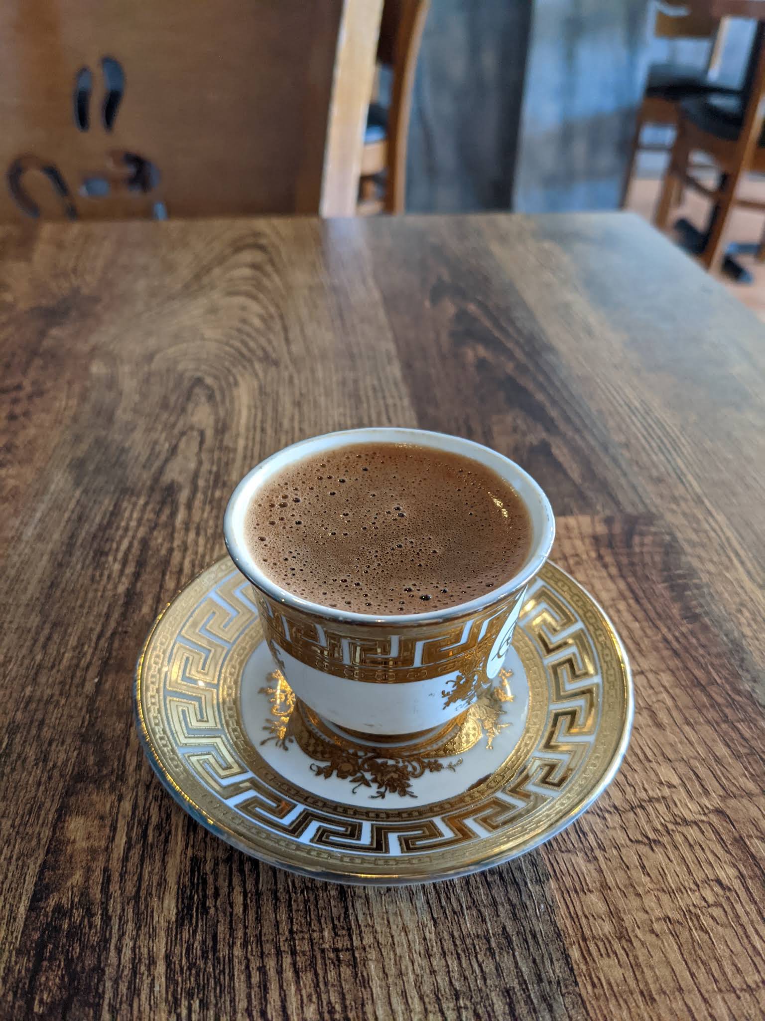 A complete Turkish coffee cup and saucer with gold geometric decoration at Lamarina